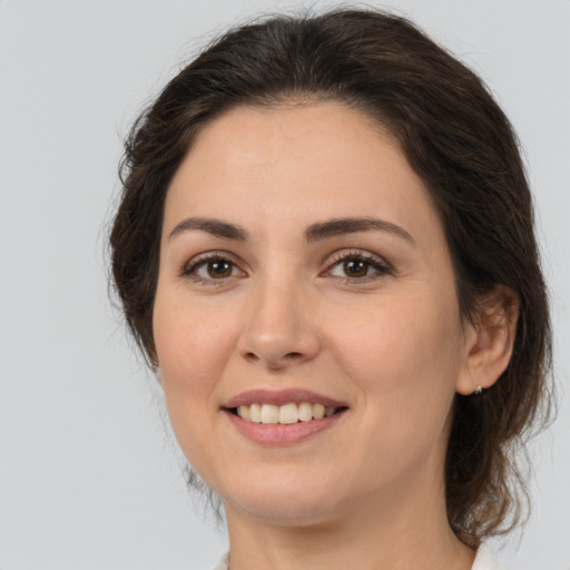 Joyful white young-adult female with medium  brown hair and brown eyes