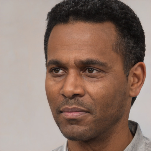 Neutral latino adult male with short  black hair and brown eyes