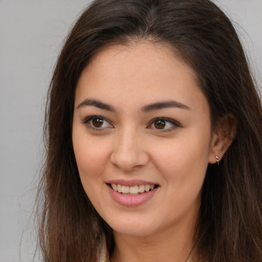 Joyful white young-adult female with long  brown hair and brown eyes