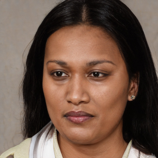 Neutral latino adult female with medium  brown hair and brown eyes