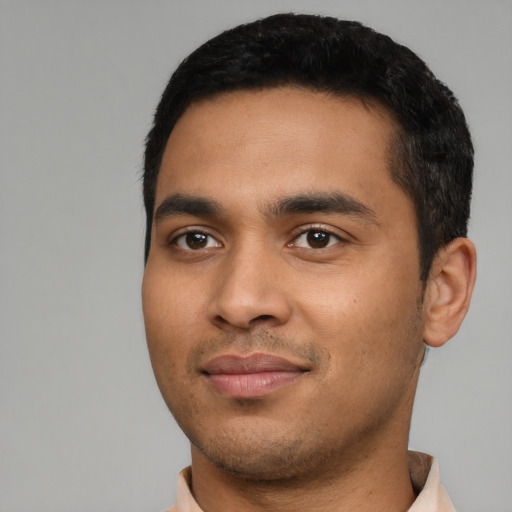 Joyful latino young-adult male with short  black hair and brown eyes