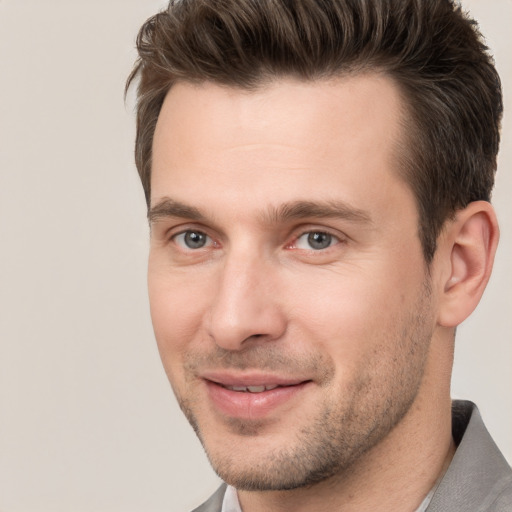 Joyful white adult male with short  brown hair and brown eyes