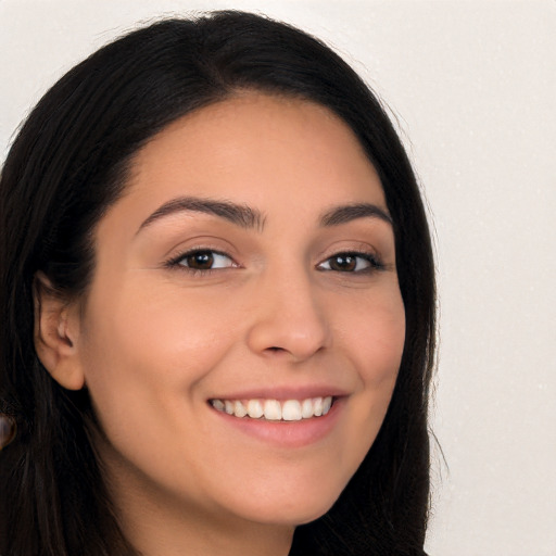 Joyful white young-adult female with long  black hair and brown eyes