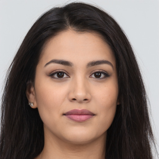 Joyful latino young-adult female with long  brown hair and brown eyes