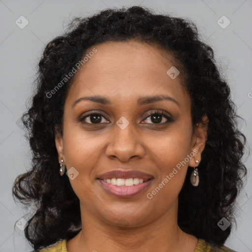 Joyful black young-adult female with long  brown hair and brown eyes