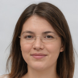 Joyful white adult female with long  brown hair and brown eyes