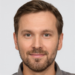 Joyful white adult male with short  brown hair and brown eyes