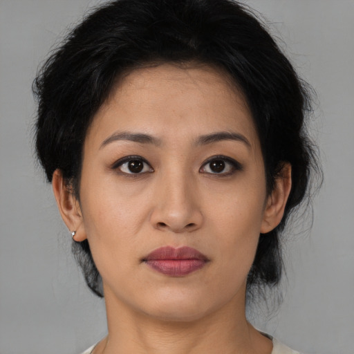 Joyful asian young-adult female with medium  black hair and brown eyes