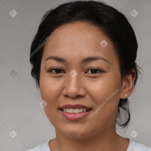 Joyful asian adult female with medium  brown hair and brown eyes