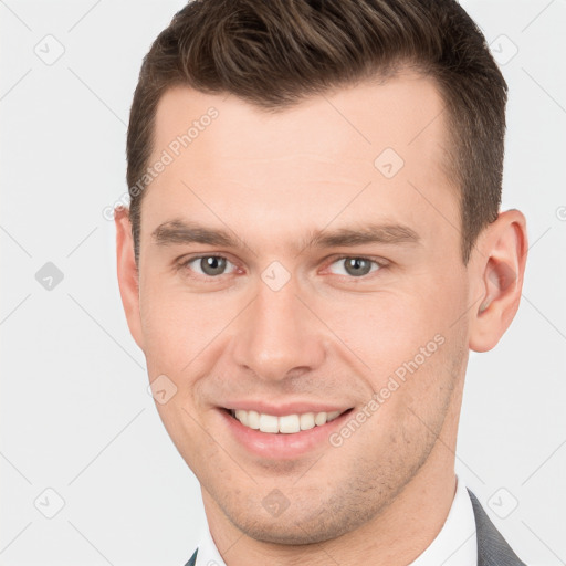 Joyful white young-adult male with short  brown hair and brown eyes