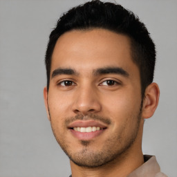 Joyful latino young-adult male with short  black hair and brown eyes