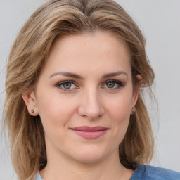 Joyful white young-adult female with medium  brown hair and blue eyes