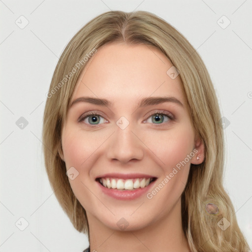 Joyful white young-adult female with long  brown hair and green eyes