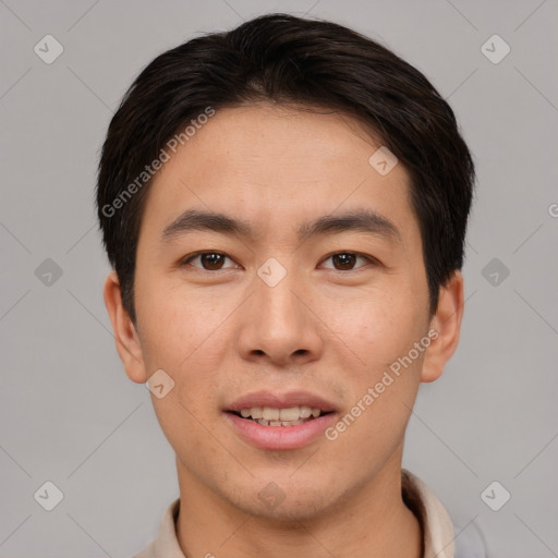 Joyful asian young-adult male with short  brown hair and brown eyes