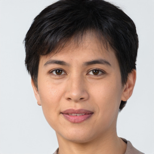 Joyful asian young-adult female with short  brown hair and brown eyes