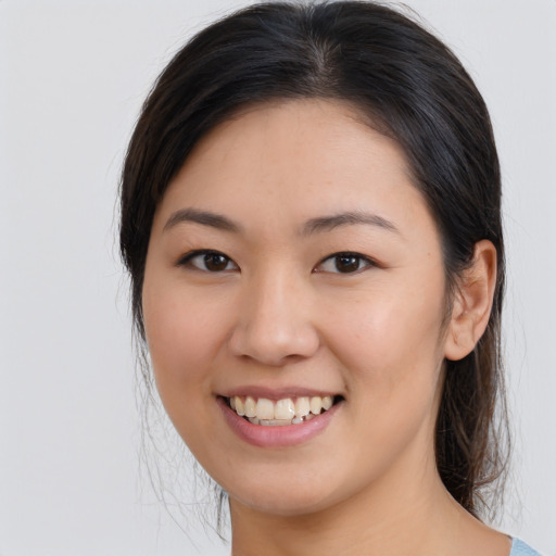 Joyful asian young-adult female with medium  brown hair and brown eyes