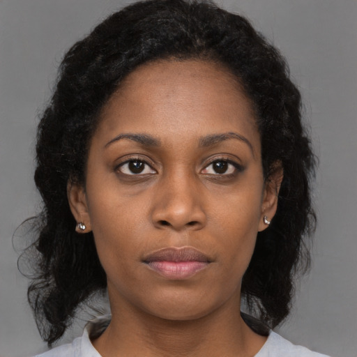 Neutral black young-adult female with medium  brown hair and brown eyes