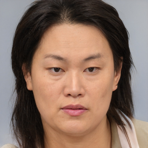 Neutral asian adult female with medium  brown hair and brown eyes