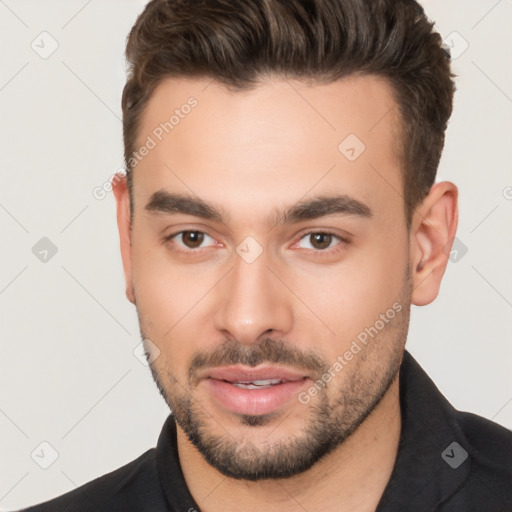 Joyful white young-adult male with short  brown hair and brown eyes