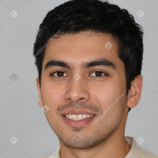 Joyful white young-adult male with short  black hair and brown eyes