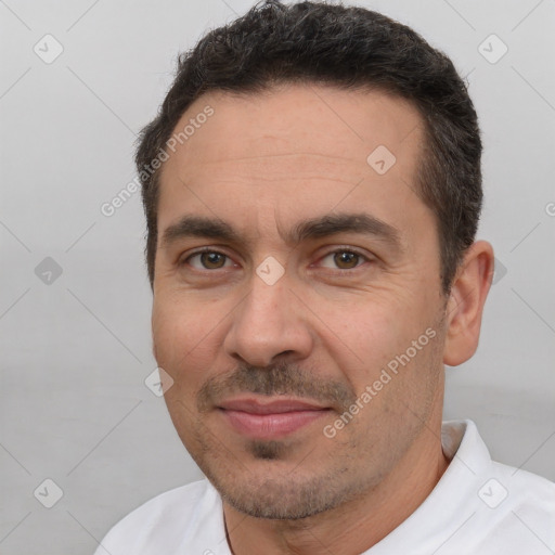 Joyful white adult male with short  brown hair and brown eyes