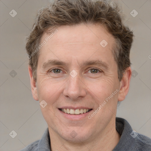 Joyful white adult male with short  brown hair and grey eyes