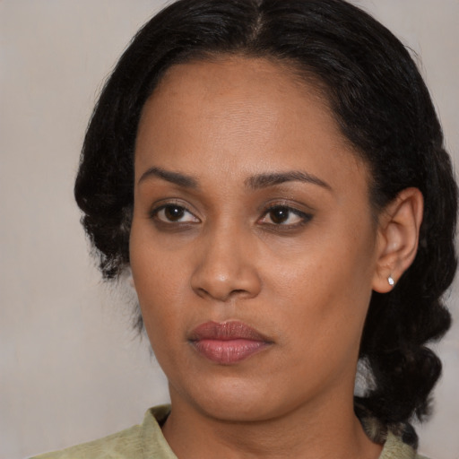 Joyful black young-adult female with medium  black hair and brown eyes