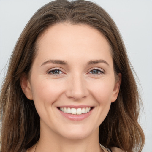 Joyful white young-adult female with long  brown hair and grey eyes