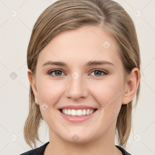 Joyful white young-adult female with medium  brown hair and grey eyes