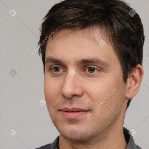 Joyful white adult male with short  brown hair and brown eyes