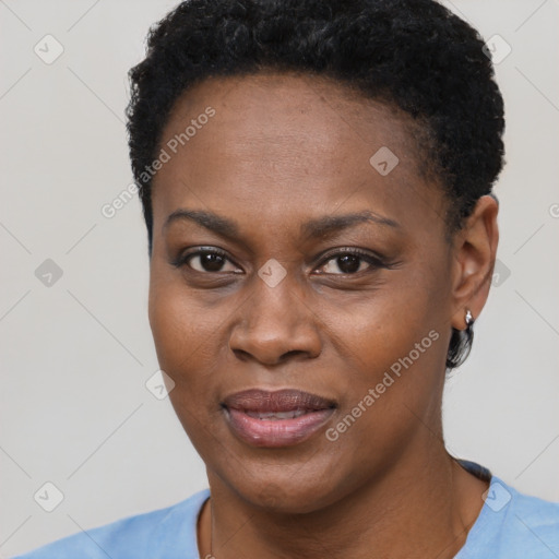 Joyful black young-adult female with short  black hair and brown eyes