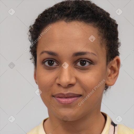 Joyful black young-adult female with short  brown hair and brown eyes