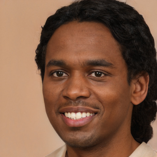 Joyful black young-adult male with short  black hair and brown eyes