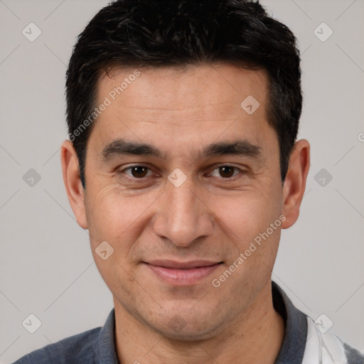 Joyful white adult male with short  black hair and brown eyes