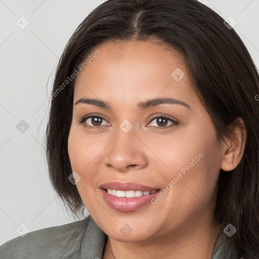 Joyful white young-adult female with long  brown hair and brown eyes