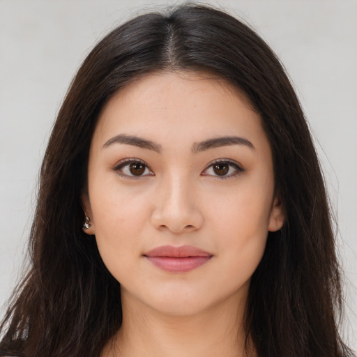 Joyful asian young-adult female with long  brown hair and brown eyes