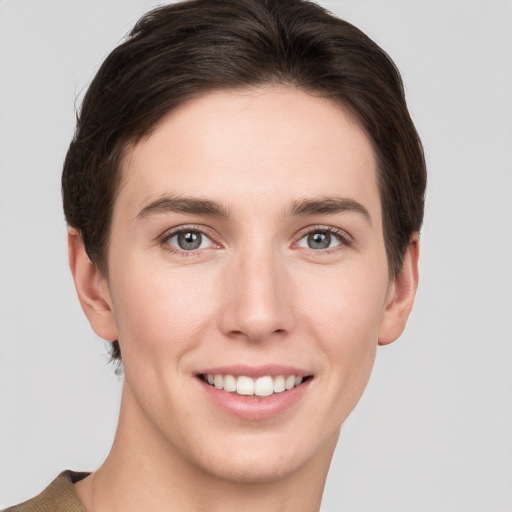 Joyful white young-adult female with short  brown hair and grey eyes