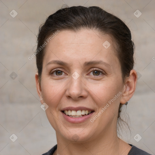 Joyful white adult female with short  brown hair and grey eyes