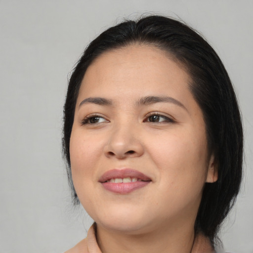 Joyful asian young-adult female with medium  black hair and brown eyes