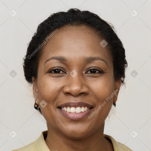Joyful black adult female with short  brown hair and brown eyes