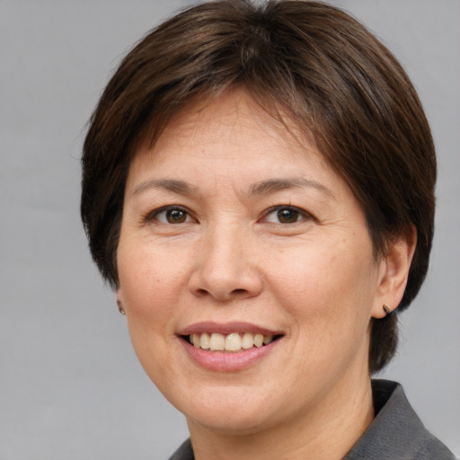 Joyful white adult female with medium  brown hair and brown eyes