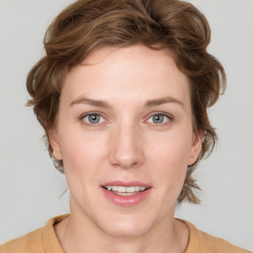 Joyful white young-adult female with medium  brown hair and blue eyes