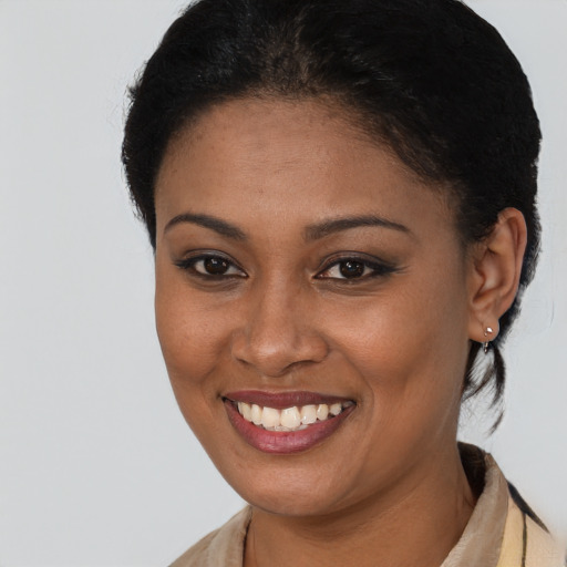 Joyful black young-adult female with short  brown hair and brown eyes