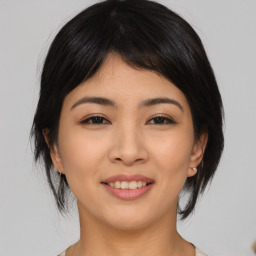 Joyful asian young-adult female with medium  brown hair and brown eyes