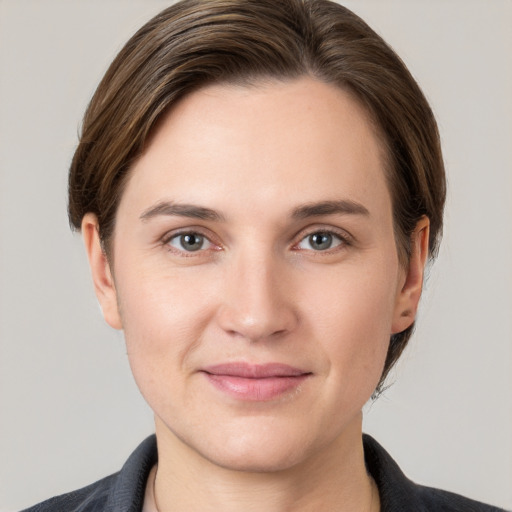 Joyful white young-adult female with short  brown hair and grey eyes