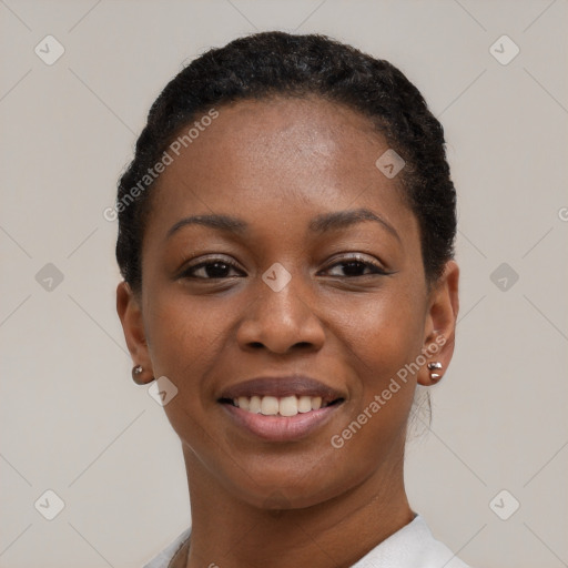 Joyful black young-adult female with short  black hair and brown eyes