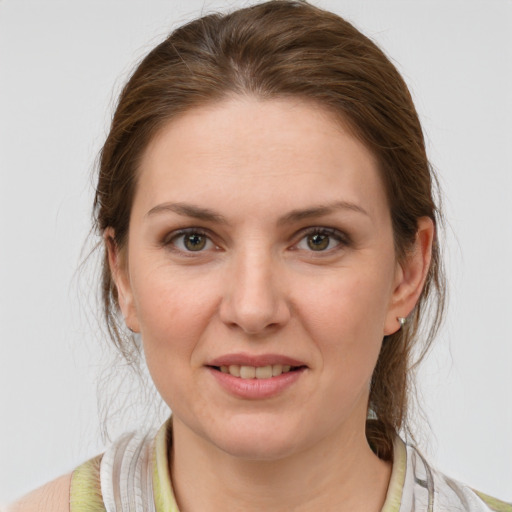 Joyful white young-adult female with medium  brown hair and grey eyes