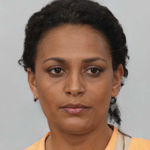 Neutral latino adult female with short  brown hair and brown eyes