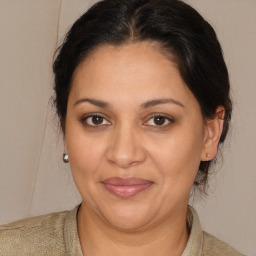 Joyful latino adult female with medium  brown hair and brown eyes