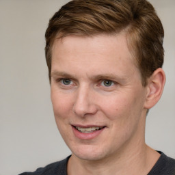 Joyful white adult male with short  brown hair and grey eyes